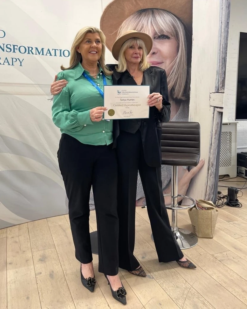 Tanya Hames receiving her RTT Certified Hypnotist certificate from Marisa Peer